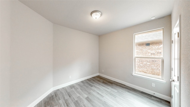 unfurnished room with light hardwood / wood-style floors