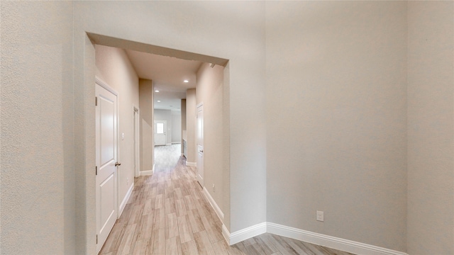 corridor with light hardwood / wood-style flooring