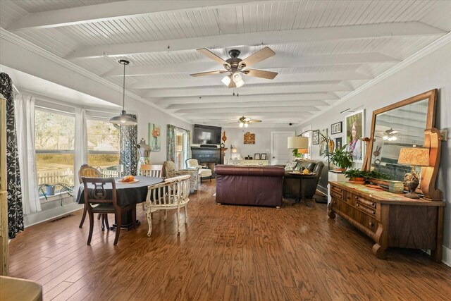 dining space with beamed ceiling, dark hardwood / wood-style floors, and ceiling fan