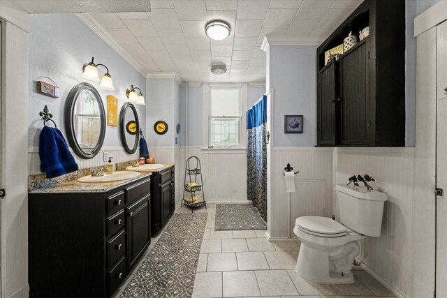 bathroom featuring a shower with curtain, tile patterned floors, crown molding, toilet, and vanity