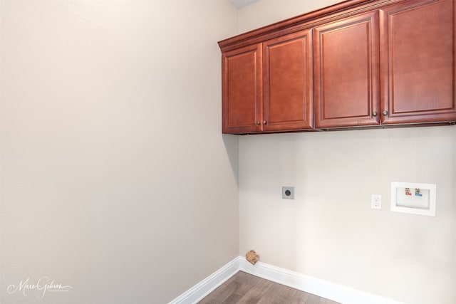 laundry area featuring hookup for an electric dryer, hookup for a washing machine, wood-type flooring, and cabinets