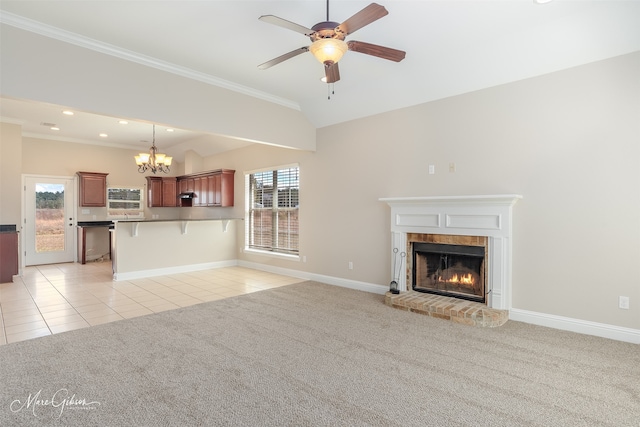 unfurnished living room featuring a wealth of natural light, a fireplace, and light colored carpet