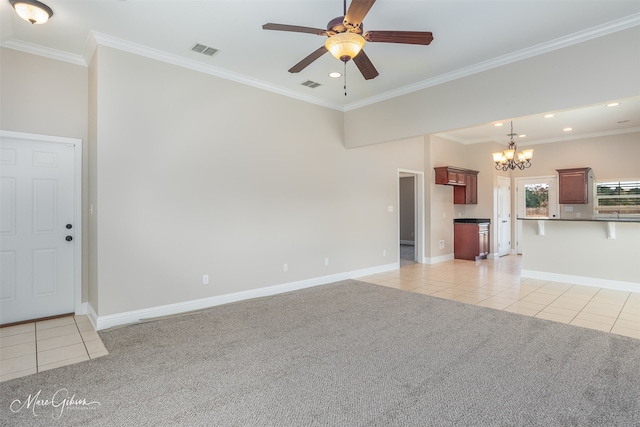 unfurnished living room featuring ceiling fan with notable chandelier, ornamental molding, and light colored carpet