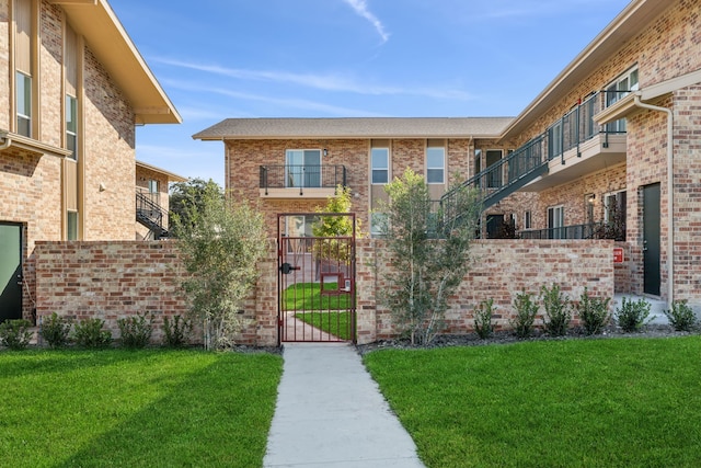 exterior space with a balcony and a front lawn