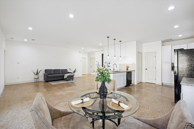 dining area featuring dark speckled floor, recessed lighting, and baseboards