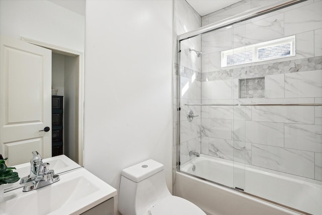 full bath with toilet, enclosed tub / shower combo, and vanity
