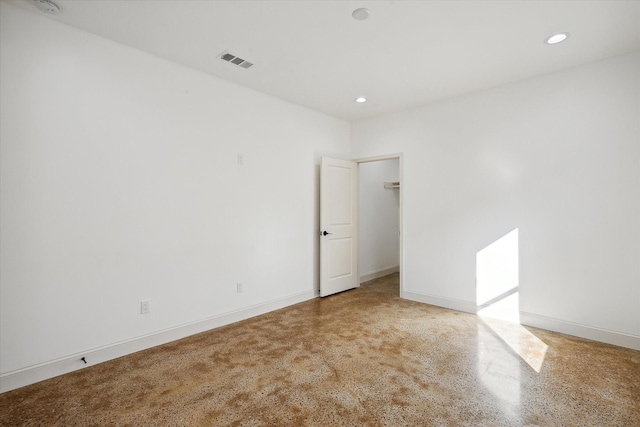 unfurnished room with recessed lighting and baseboards