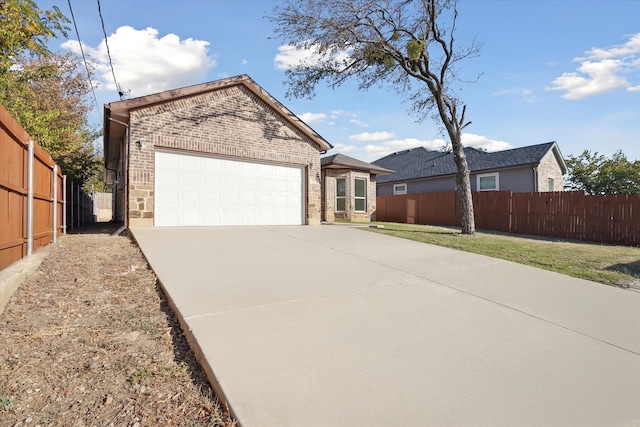 single story home with brick siding, an attached garage, and concrete driveway