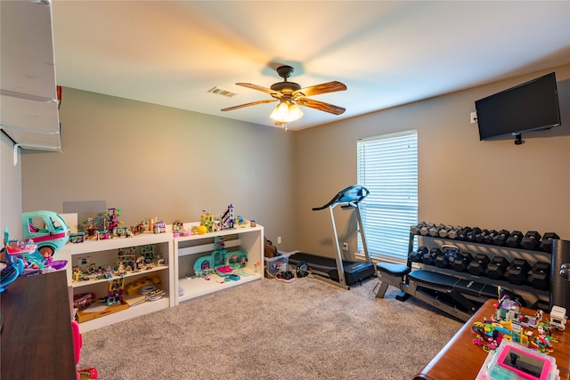 workout area with carpet flooring and ceiling fan