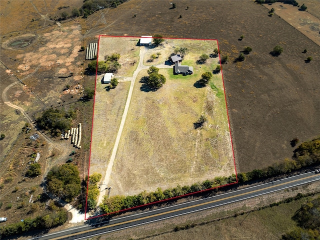 birds eye view of property with a rural view