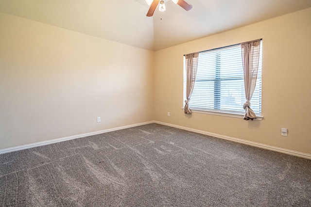 carpeted spare room featuring ceiling fan and vaulted ceiling