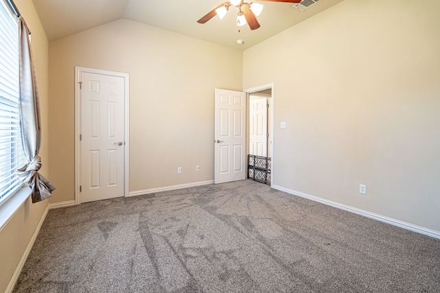 unfurnished room with lofted ceiling, carpet floors, and ceiling fan