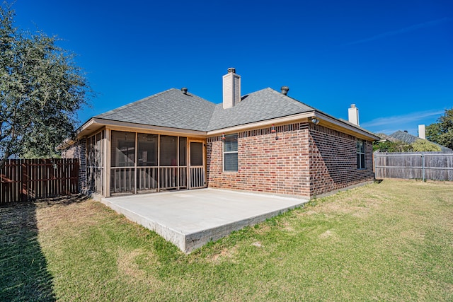 back of house featuring a patio, a sunroom, and a lawn