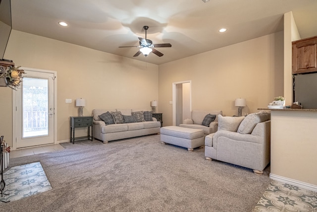 carpeted living room with ceiling fan