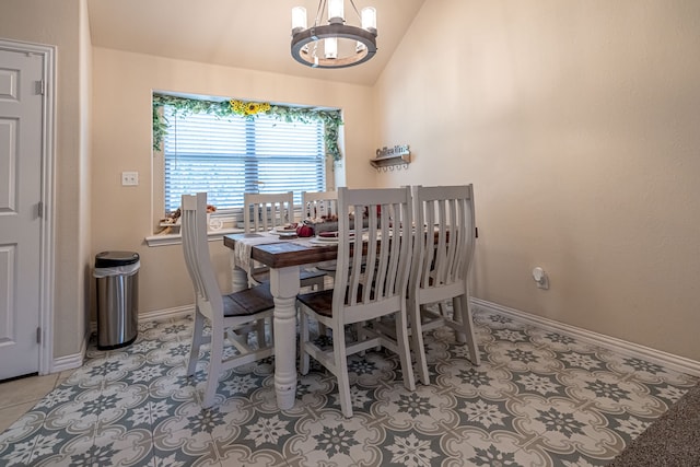 tiled dining room with an inviting chandelier and vaulted ceiling