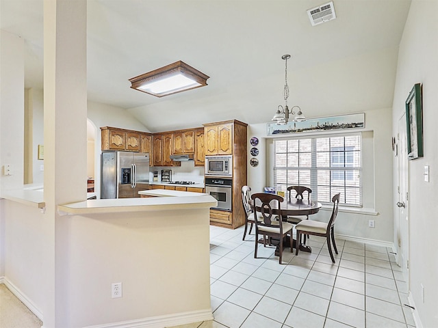 kitchen with visible vents, light countertops, lofted ceiling, appliances with stainless steel finishes, and an inviting chandelier