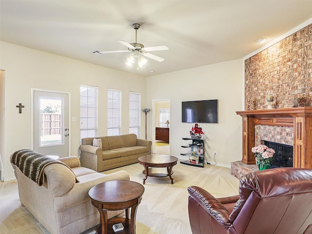 living area featuring light carpet, a fireplace, baseboards, and ceiling fan