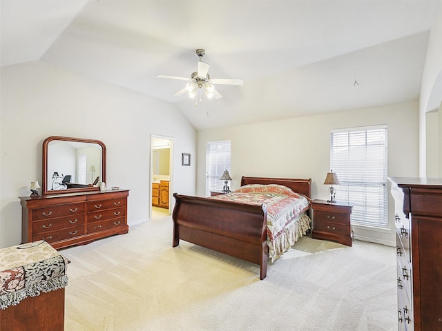 bedroom with light carpet, a ceiling fan, ensuite bathroom, and lofted ceiling