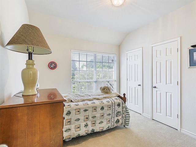 bedroom featuring lofted ceiling, carpet, and baseboards