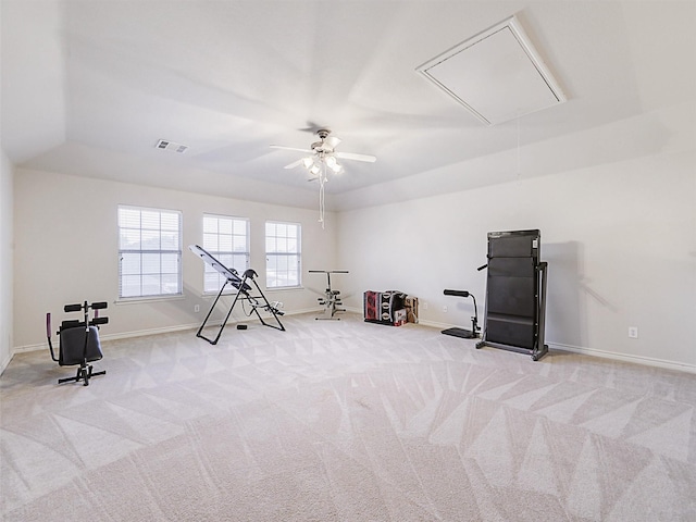 exercise area featuring visible vents, carpet floors, baseboards, attic access, and ceiling fan