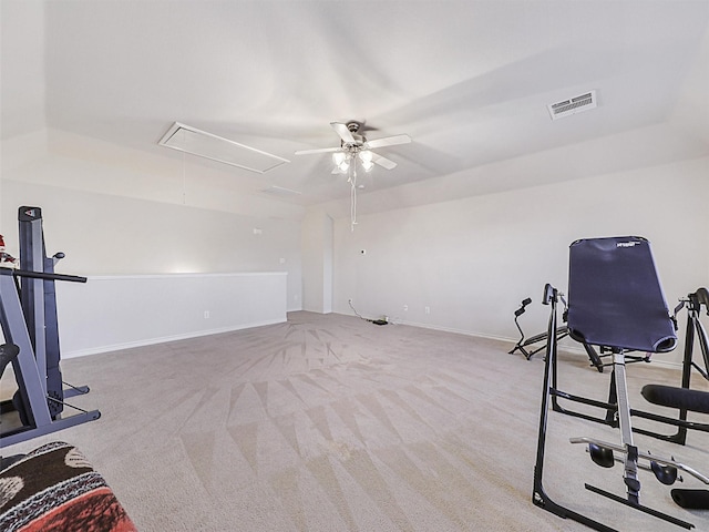 workout area featuring baseboards, visible vents, attic access, ceiling fan, and carpet flooring