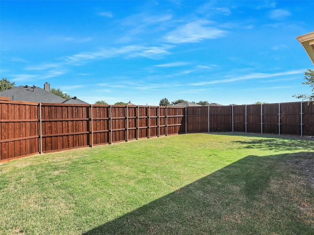 view of yard with a fenced backyard