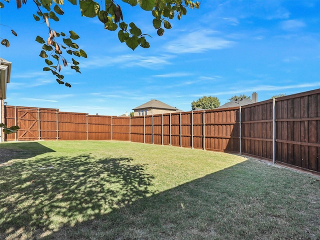 view of yard with a fenced backyard