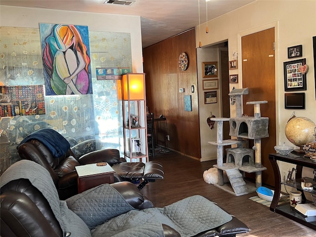 living room with wooden walls and dark hardwood / wood-style floors