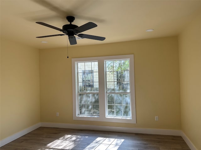 unfurnished room featuring dark hardwood / wood-style flooring and ceiling fan