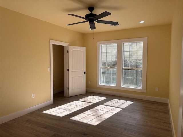 spare room featuring hardwood / wood-style flooring and ceiling fan