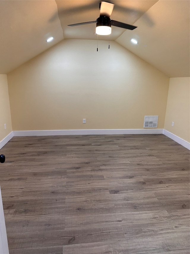 bonus room featuring dark hardwood / wood-style flooring, lofted ceiling, and ceiling fan