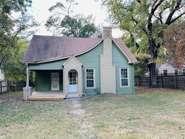 111 Pecan St, Terrell, TX 75160 - view of front of home featuring a chimney, a porch, a front lawn, and a fenced backyard