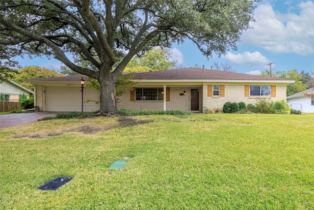 ranch-style home with a front yard and a garage