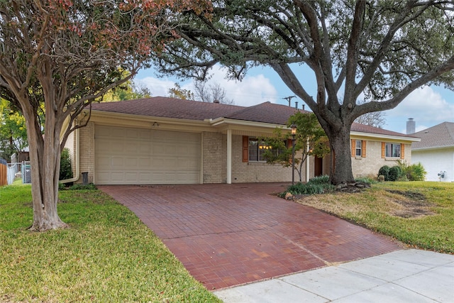 ranch-style home with a garage and a front yard