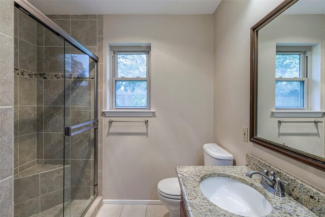 bathroom featuring tile patterned floors, a shower with shower door, and a wealth of natural light