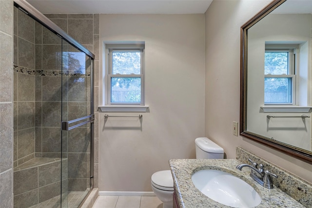 bathroom featuring a shower with shower door, tile patterned floors, and plenty of natural light