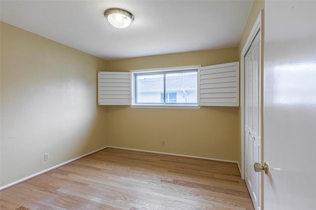 unfurnished bedroom with light hardwood / wood-style floors and a closet