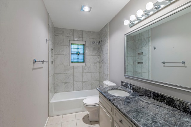 full bathroom with tile patterned floors, vanity, tiled shower / bath combo, and toilet