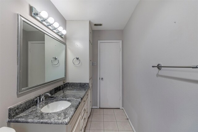 bathroom featuring tile patterned flooring and vanity