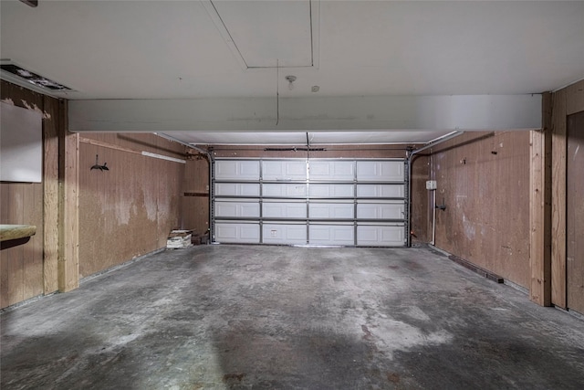 garage featuring wooden walls