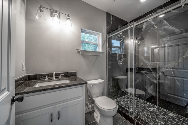 bathroom with vanity, toilet, and an enclosed shower