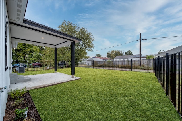 view of yard with a patio and central AC unit