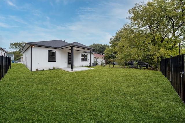 rear view of house featuring a yard and central AC unit