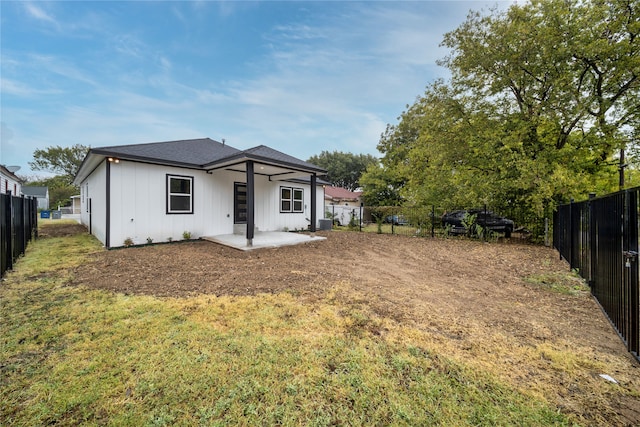 back of house featuring a patio, a lawn, and central AC unit