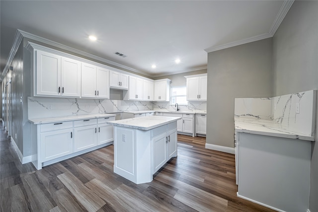 kitchen featuring a kitchen island, white cabinets, and dark hardwood / wood-style flooring