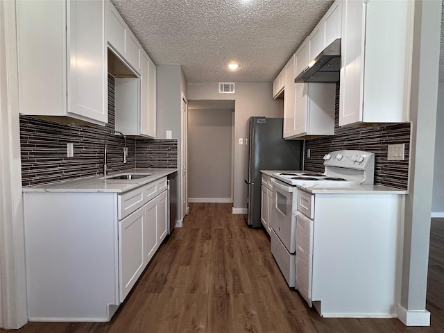 kitchen featuring white cabinetry, sink, stainless steel appliances, and wall chimney range hood