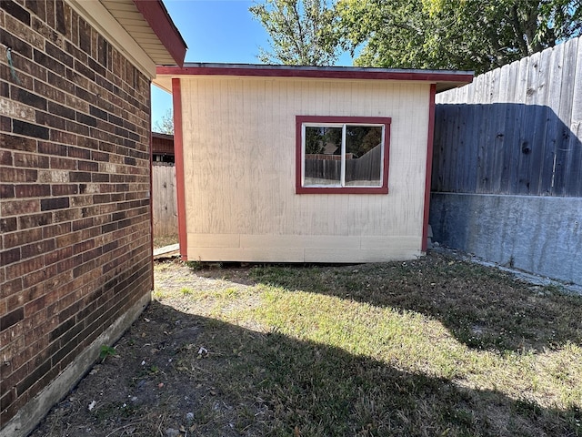 view of side of home with a lawn