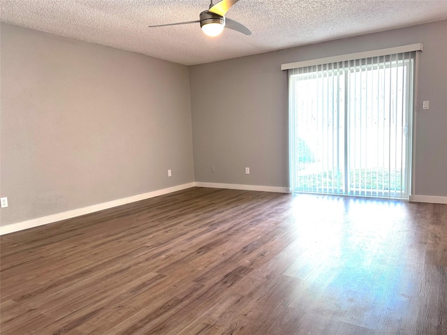 unfurnished room with ceiling fan, dark hardwood / wood-style flooring, and a textured ceiling