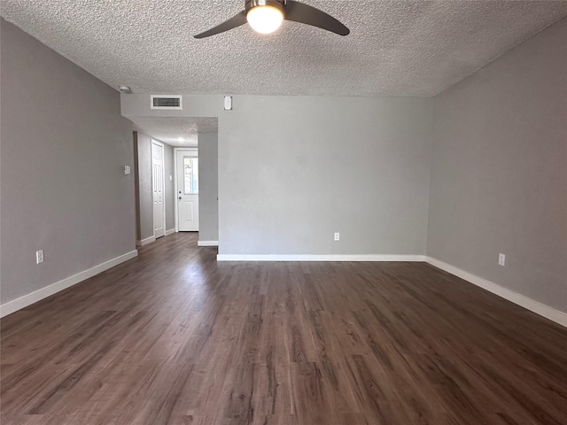 spare room with a textured ceiling, dark hardwood / wood-style floors, and ceiling fan