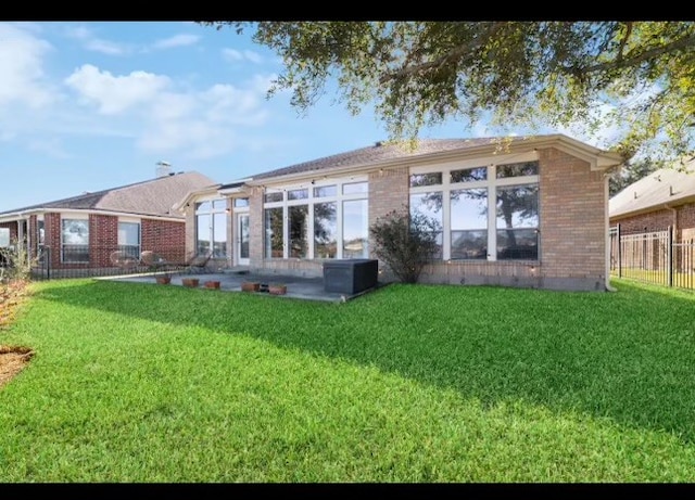 rear view of house with a lawn